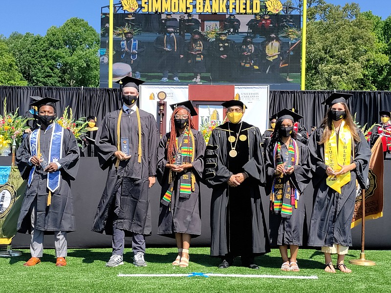 Winners of the Chancellor's Medallion awards pose with UAPB Chancellor Laurence B. Alexander, third from right, during the schools' spring graduation at Simmons Bank Field on May 8, 2021. (Pine Bluff Commercial/I.C. Murrell)