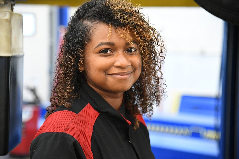 NPC students, and Toyota employee, Judaea Parks, stands in the shop at NPC.