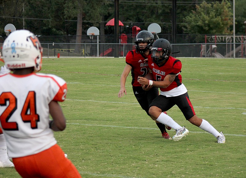 Cutter Morning Star quarterback La Shawn Jones (5) tucks the ball for a run during a Sept. 3 game against Little Rock Hall. The Eagles will travel to Hermitage this week to face the Hermits. - Photo by James Leigh of The Sentinel-Record