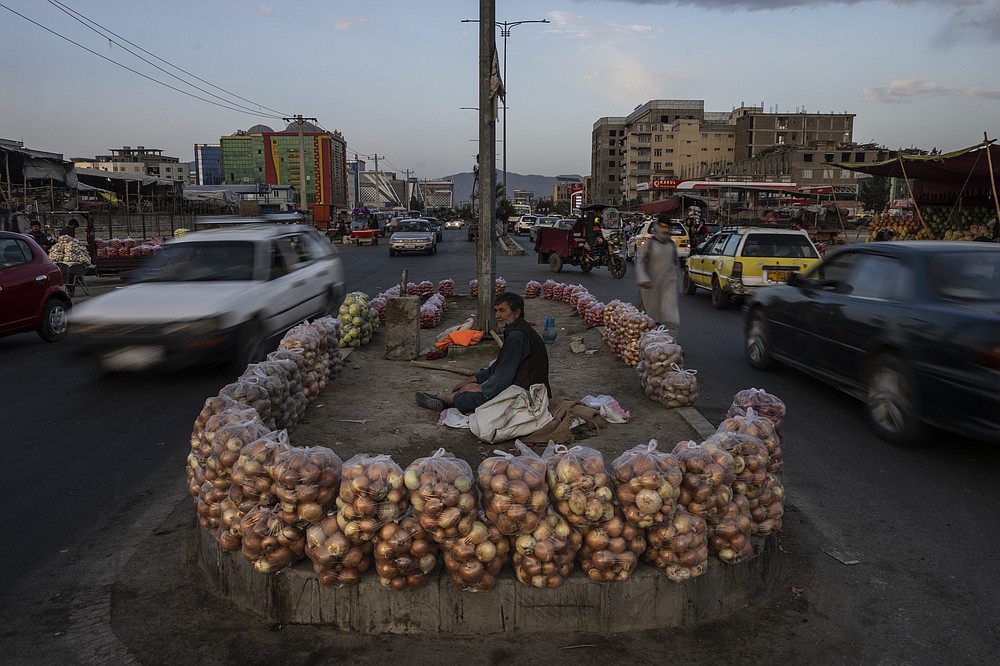 An Afghan man sells fruit in the middle of a street in Kabul, Afghanistan, Wednesday, Sept. 22, 2021. (AP Photo/Bernat Armangue)