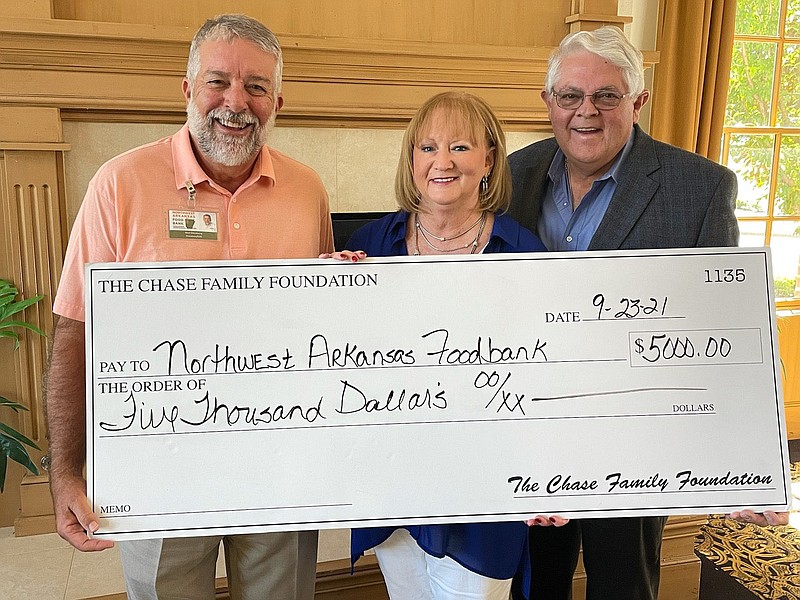 Kent Eikenberry, president and chief executive officer, Northwest Arkansas Food Bank, accepts a check representing a $5,000 donation from the Chase Foundation. Representing the Chase Foundation are Susan Chase and John Bakker. The Chase Foundation helps fight food insecurity in older adults.

(Courtesy Photo)