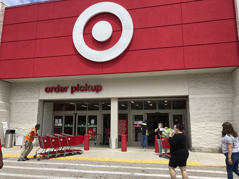 Customers arrive at a Target store, Wednesday, June 2, 2021, in North Miami Beach, Fla.  Target says Thursday, Sept. 23,  it will hire fewer seasonal workers than last year and instead offer more hours to its current hourly staffers as it navigates a tight labor market.  (AP Photo/Wilfredo Lee)