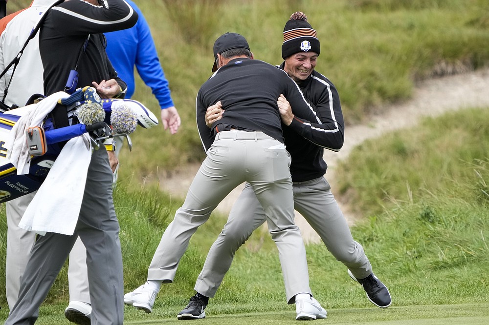 Team Europe's Viktor Hovland and Team Europe's Paul Casey have some fun on the ninth hole during a practice day at the Ryder Cup at the Whistling Straits Golf Course Thursday, Sept. 23, 2021, in Sheboygan, Wis. (AP Photo/Ashley Landis)