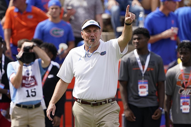 Florida head coach Dan Mullen directs player warm ups before an NCAA college football game against Alabama, Saturday, Sept. 18, 2021, in Gainesville, Fla. (AP Photo/John Raoux)