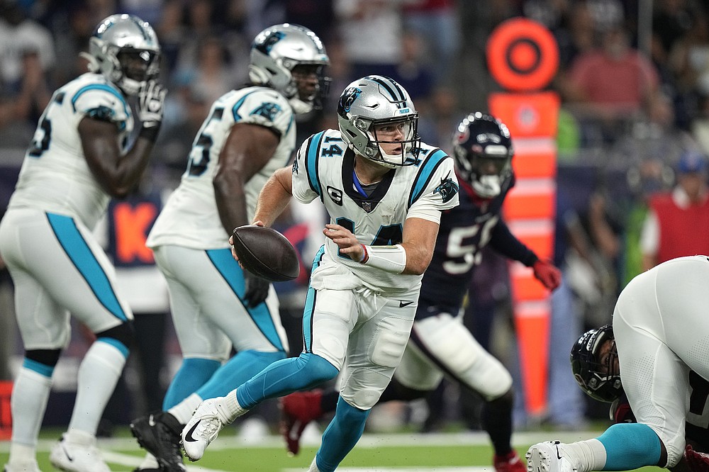 Carolina Panthers quarterback Sam Darnold (14) scrambles out of the pocket against the Houston Texans during the first half of an NFL football game Thursday, Sept. 23, 2021, in Houston. (AP Photo/Eric Christian Smith)