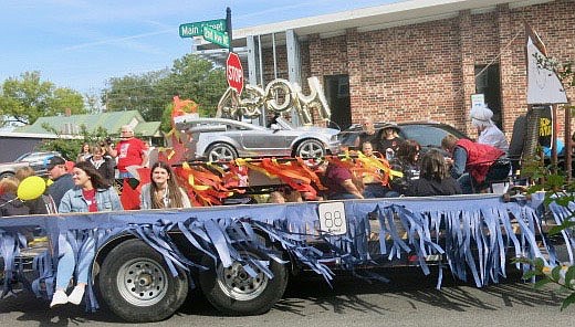 Westside Eagle Observer/SUSAN HOLLAND
Members of the HOSA Club at Gravette High School decorated their homecoming parade float with a sleek race car, perhaps suggesting that the Lions would speed right past Elkins in Friday night's game, but the outcome was not what they had hoped.