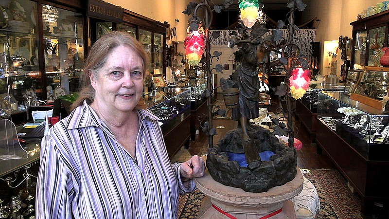 Owner Suzanne Tucker talks about her business, Historic District Antiques, on Thursday. - Photo by Tyler Wann of The Sentinel-Record