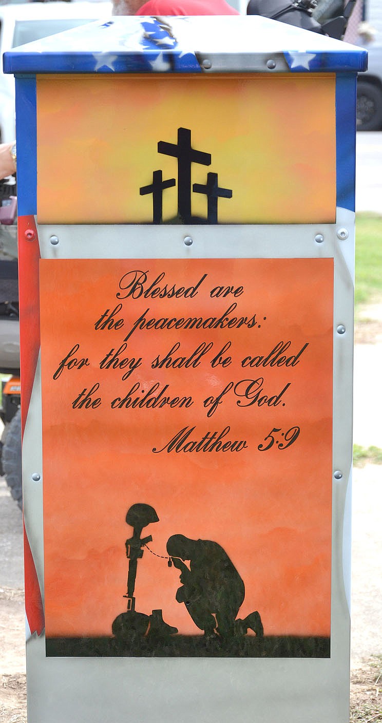 The design on the back of the flag drop box includes a Scripture: &quot;Blessed are the peacemakers: for they shall be called the children of God.&quot; (Matthew 5:9)