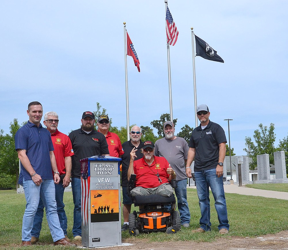 TIMES photograph by Annette Beard
Veterans and members of the Pea Ridge Wood-Hall Veterans of Foreign Wars show off the new flag drop box painted and refurbished by Purvis Cope of Sumit Truck Group. Veterans with Cope, second from left, include Braxton Hurst, John Ruddick, Terry Thurman, Jerry Burton, George Kuhnert, Howard Schuettpelz and John Vincent.
