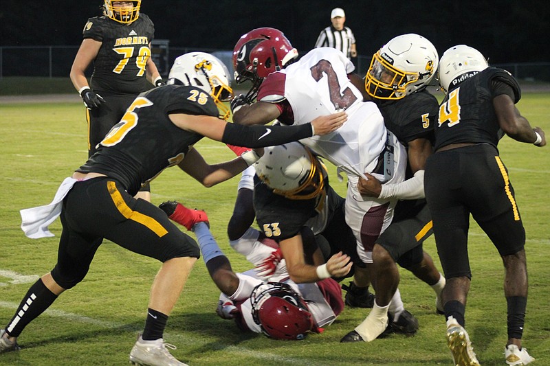 Harmony Grove outside linebacker Jermaine Edwards (#5), defensive end Logan McCann (#53), linebacker Preston Hendrix (#25), and cornerback Titus Lockhart (#4) all swarm to Dollarway running back Javion Cain on a run.