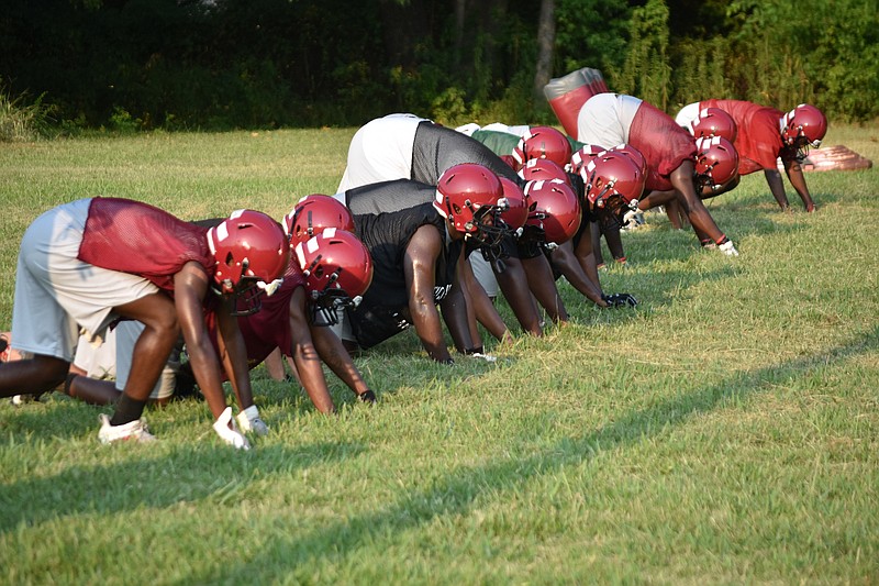 Dollarway High School football players line up for "bear claw" drills during an August practice. (Pine Bluff Commercial/I.C. Murrell)