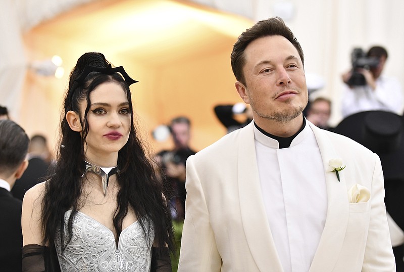 FILE - Grimes, left, and Elon Musk attend The Metropolitan Museum of Art's Costume Institute benefit gala in New York on May 7, 2018. The Tesla and SpaceX founder tells the New York Post that he and the Canadian singer are &#x201c;semi-separated.&#x201d; But he says they remain on good terms, she still lives at his house in California and they continue to raise their 1-year-old son together. (Photo by Charles Sykes/Invision/AP, File)