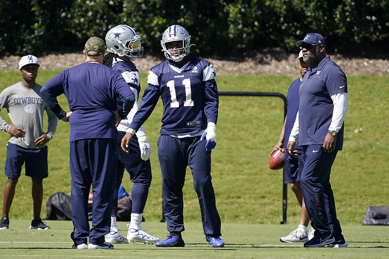Dallas Cowboys linebacker Micah Parsons (11) talks with team staff as they run through drills during practice at the team's NFL football training facility in Frisco, Texas, Thursday, Sept. 23, 2021. (AP Photo/Tony Gutierrez)