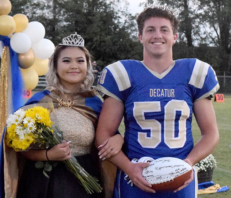 Westside Eagle Observer/MIKE ECKELS
Queen Lilly Lee (left) and king Waylon Harrington walk down the 50 yard line at Bulldog Stadium after receiving their crowns during the 2021 Decatur Homecoming coronation ceremony in Decatur Friday night.