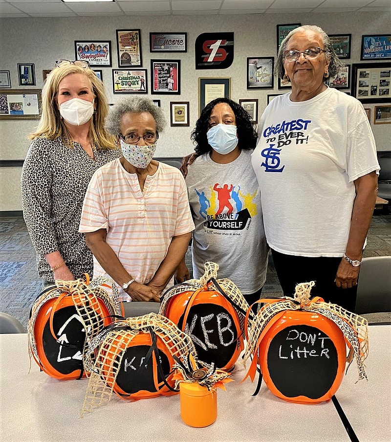 Members of Keep El Dorado Beautiful look over decorative ideas for fall and Halloween. Members, from left, are Jeri Ratcliff, Ora Williams, Anjanett Kemp and Janis Van Hook, KEB president. Ratcliff used Tide Pod containers, chalkboard paint and ribbons to fashion the jack-o-latern-like crafts, explaining that battery-operated tea light candles may be placed inside. Ratcliff presented the lanterns during a regular KEB meeting on Sept. 20 as a unique idea for recycling. (Contributed)