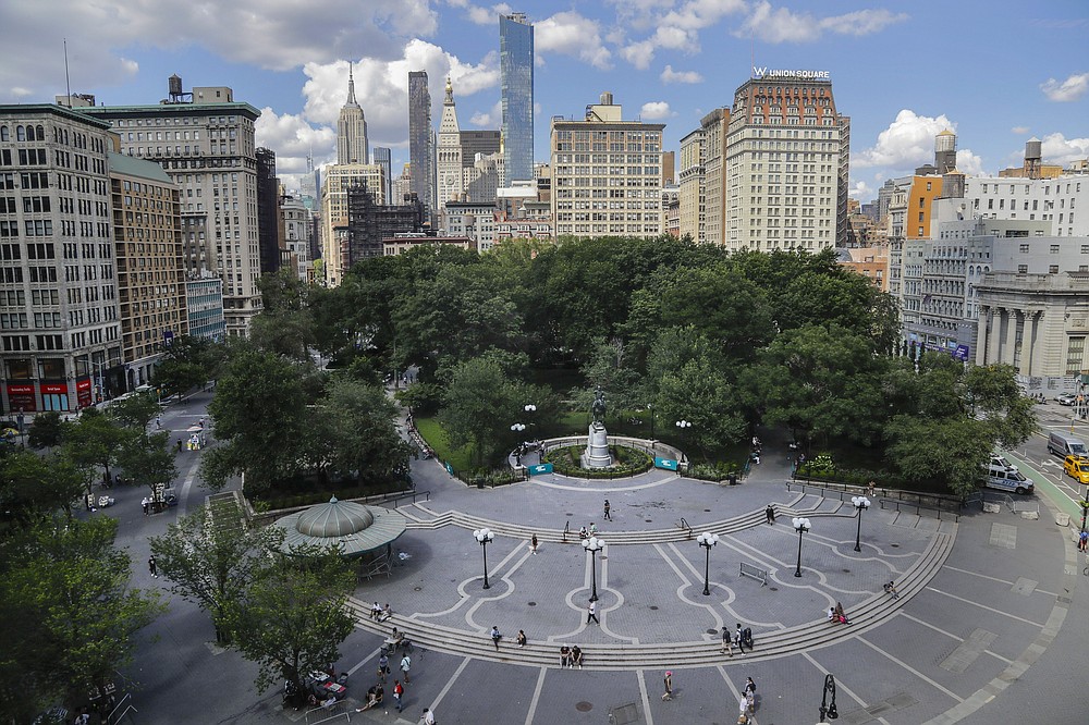 FILE - In this July 14, 2020, file photo pedestrians pass Union Square in New York. The surge in the nation’s urban population could give these urban centers greater influence in reshaping the balance of power in Washington as congressional redistricting gets under way. New York in particular is giving Democrats hope. The most populous city in the United States added some 629,000 new residents, more people than live in Wyoming.  (AP Photo/Frank Franklin II, File)