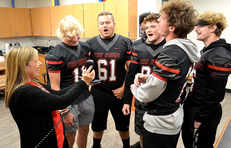 TIMES photograph by Annette Beard

Primary School principal Darah Bennett held the phone that broadcast &#x201c;The Star Spangled Banner&#x201d; sung by several Blackhawk football players to students and staff in the Pea Ridge Primary School Friday morning. Players who sang included Will Anderson, Connor Pierce, Devon Hopkins, Braidon McCarley, Cade Mann and Joe Adams.