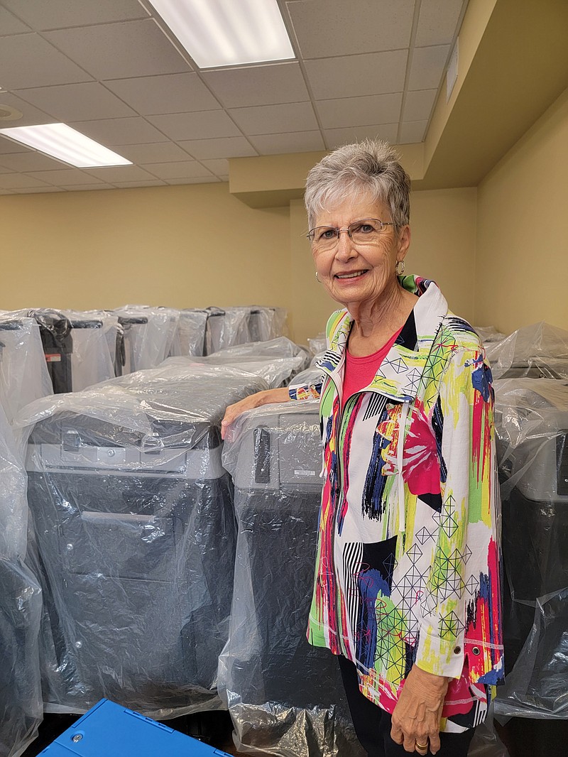 Linda Crawford, Miller County election coordinator, stands with some of Miller County election equipment the county received in 2017. (Staff photo by Christy Busby Worsham)