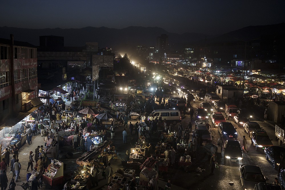 Afghans shop at a local market in Kabul, Afghanistan, Sunday, Sept. 26, 2021. (AP Photo/Felipe Dana)