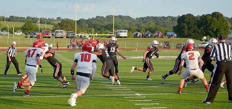 Al Gaspeny/Special to the McDonald County Press
Quarterback Cole Martin watches as Destyn Dowd finds running room against Aurora in the season opener. After last week's 35-7 victory over Seneca, the Mustangs are averaging 30.2 points per game.