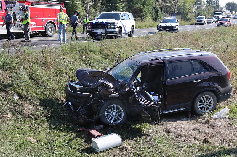 Piney Fire Department volunteers, Arkansas State Police, Garland County sheriff’s deputies and LifeNet personnel work the scene of a two-vehicle wreck in the 3700 block of Albert Pike Road Tuesday morning. - Photo by Richard Rasmussen of The Sentinel-Record