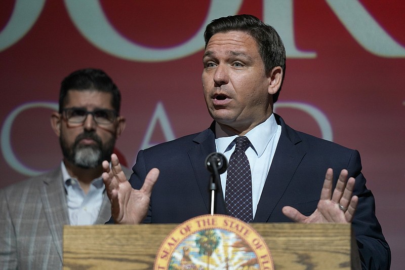 FILE - In this Tuesday, Sept. 14, 2021, file photo, Florida Gov. Ron DeSantis speaks at the Doral Academy Preparatory School in Doral, Fla. Florida filed suit against President Joe Biden's administration Tuesday, Sept. 28, 2021, claiming his immigration policy is illegal, and DeSantis signed an order barring state agencies from assisting with the relocation of undocumented immigrants arriving in the state. (AP Photo/Wilfredo Lee. File)