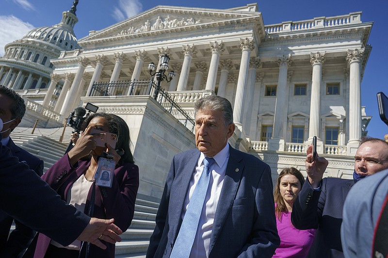 Sen. Joe Manchin, D-W.Va., a centrist Democrat vital to the fate of President Joe Biden's $3.5 trillion domestic agenda, is surrounded by reporters outside the Capitol in Washington, Wednesday, Sept. 29, 2021. Manchin and other senators were boarding a bus to attend a memorial service for the late Susan Bayh, the wife of former Senator Evan Bayh of Indiana, who died earlier in the year. (AP Photo/J. Scott Applewhite)