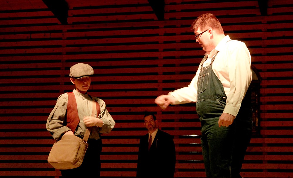 Andrew Mobley/Special to the Herald-Leader
Joe Crowell the paper boy, played by Phoenix May (left), gives a newspaper to Howie Newsome, played by Ian Bean (right), during the Siloam Springs Center for the Arts' production of &quot;Our Town&quot; on Saturday night at the Chautauqua Amphitheater in downtown Siloam Springs.