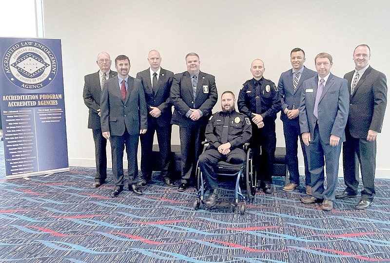 COURTESY PHOTO
The city of Prairie Grove was well-represented last week in Little Rock when Prairie Grove police officers Tyler Franks and Andrew Gibson, both pictured in the center, were honored as the 2021 Officers of the Year by the Arkansas Association of Chiefs of Police. Standing with the officers, left to right, Council members Tony Cunningham and Rick Ault, officer Mark Cluck, police Chief Chris Workman, officer Uriel Paredes, council member Doug Stumbaugh and police Capt. Jeff O'Brien.