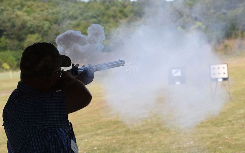 A contestant fires his muzzle-loading rifle on Sept. 24 2021 at the 66th annual Saunders Memorial Shoot in Berryville. Matches for rifle, pistol and shotgun shooters took place at the Luther Owens Park gun range in Berryville.
(NWA Democrat-Gazette/Flip Putthoff)
