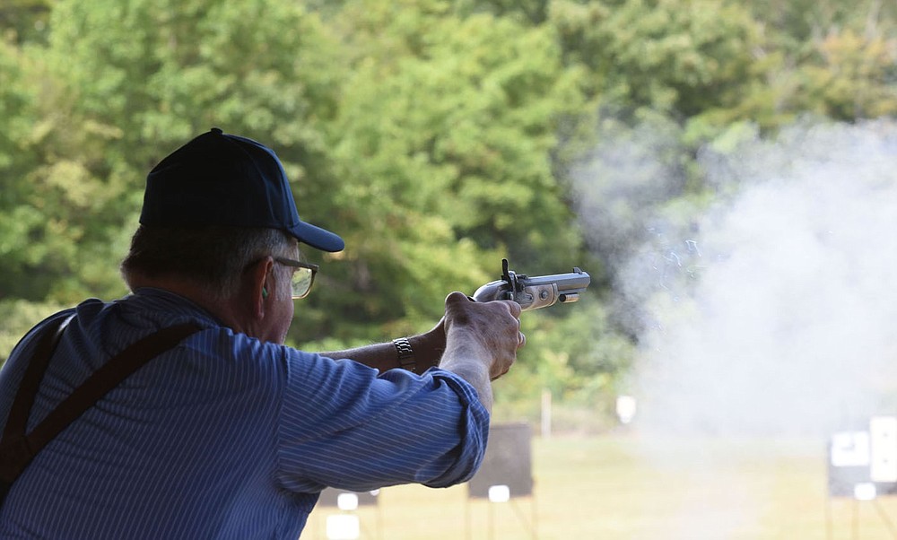 Roy Brown of Yakima, Wash., shoots his black-powder pistol on Sept. 24 2021 at the Saunders Memorial Shoot.
(NWA Democrat-Gazette/Flip Putthoff)