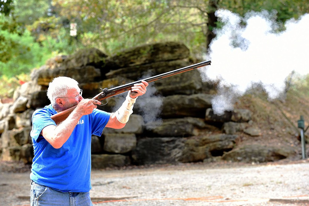 Pat Brain of Fayetteville shoots his double-barrel black-powder shotgun.
(NWA Democrat-Gazette/Flip Putthoff)