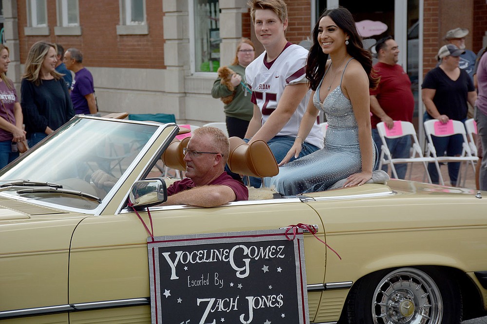 Graham Thomas / Siloam Sunday Chuck Jones leads his son Zach Jones and Yoceline Gomez in the Siloam Springs Homecoming Parade Wednesday in downtown Siloam Springs.