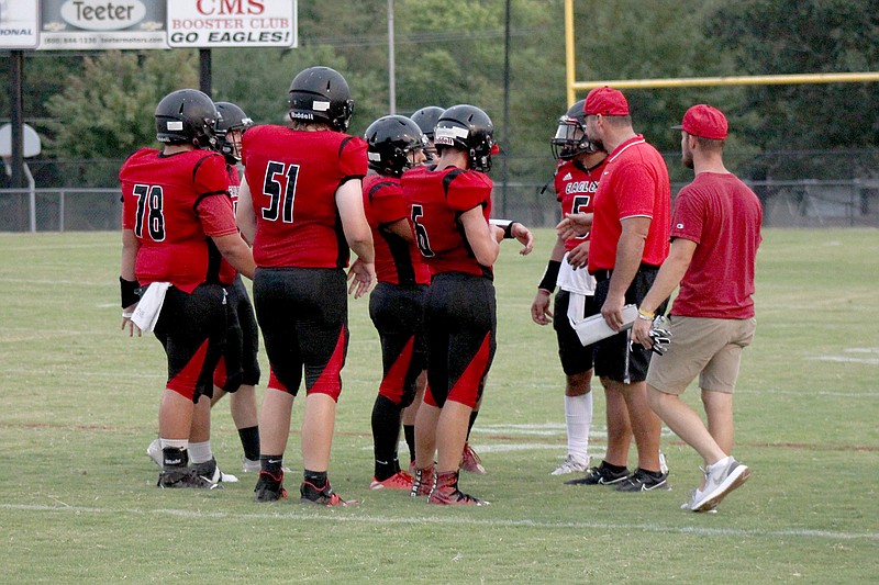 Cutter Morning Star head coach Matt Kinsinger, second from right, talks to his players during a timeout in a Sept. 3 game against Little Rock Hall. - Photo by James Leigh of The Sentinel-Record