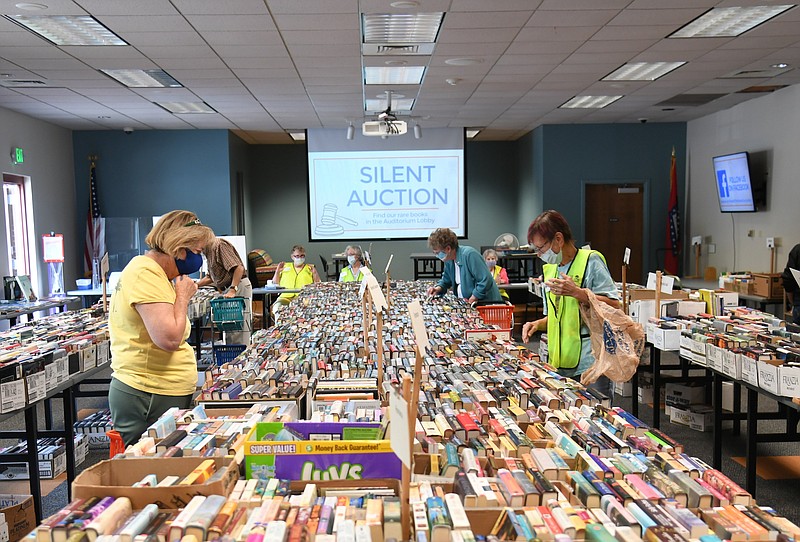 Volunteers and shoppers enjoy the Friends of the Library book sale at the Garland County Library last weekend. Peggy Young, Friends board president, said the first day of the sale, on Sept. 24, was a success with a large number of people in attendance. The money raised from the event will be used to help fund the library’s new bookmobile, she said. The library recently announced it will hold a Fall Reading Festival. - Photo by Tanner Newton of The Sentinel-Record