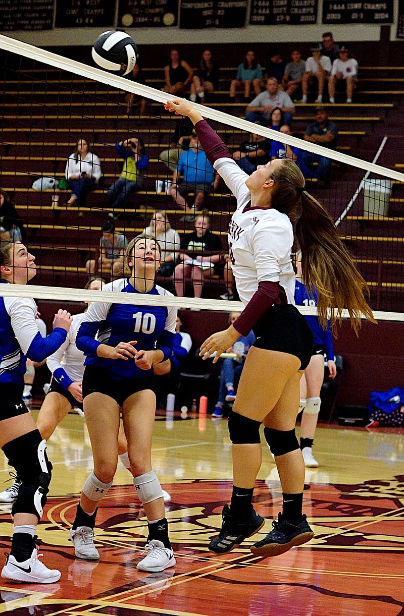 Westside Eagle Observer/RANDY MOLL
Gentry junior Madison Voyles hits one over the net to Harrison players during Thursday night play in Gentry.