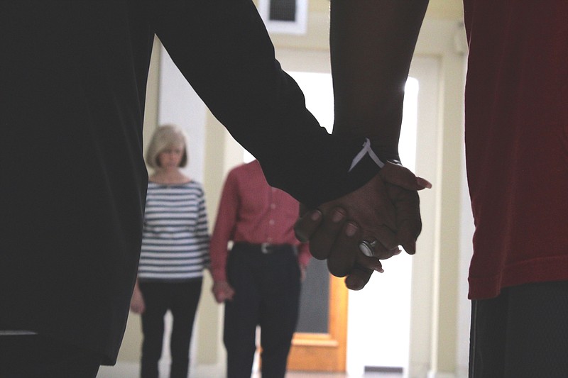 El Dorado City Council member Willie McGhee holds hands with Pastor Isaura Pulido during the kick-off to 40 Days of Prayer at City Hall in 2021. (Caitlan Butler/News-Times)