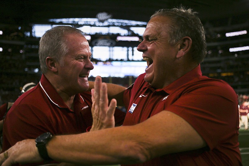 Arkansas head coach Sam Pittman hugs Arkansas athletic director Hunter Yurachek at the end of a Sept. 25 football game at AT&T Stadium in Arlington, Texas. To understand Pittman’s deep ties to today’s game against No. 2 Georgia, it’s necessary to go back 41 years. - Photo by Charlie Kaijo of NWA Democrat-Gazette