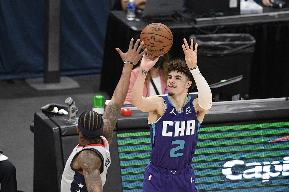 FILE - Charlotte Hornets guard LaMelo Ball (2) shoots during the second half of an NBA basketball game against Washington Wizards guard Bradley Beal in Washington, in this Sunday, May 16, 2021, file photo. LaMelo Ball made the transition from playing basketball overseas to the NBA last season look fairly easy, breezing his way to Rookie of the Year honors. Now Hornets coach James Borrego wants his point guard to take the next step. (AP Photo/Nick Wass, File)