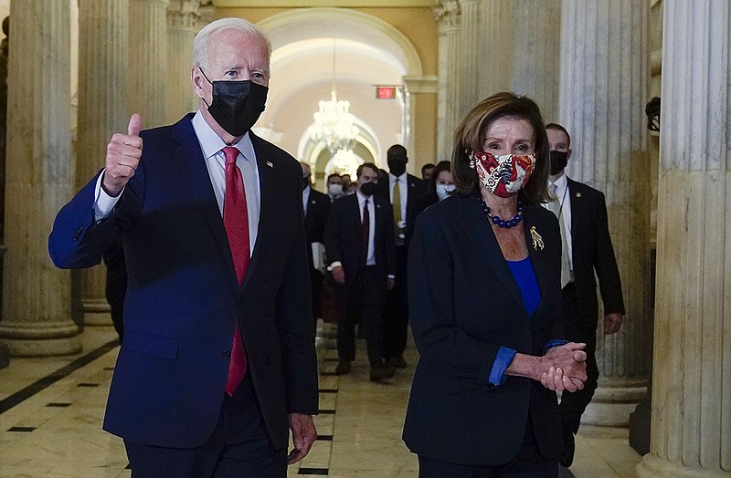President Joe Biden gives a thumbs up as he walks with House Speaker Nancy Pelosi of Calif., on Capitol Hill in Washington, Friday, Oct. 1, 2021, after attending a meeting with the House Democratic caucus to try to resolve an impasse around the bipartisan infrastructure bill. (AP Photo/Susan Walsh)