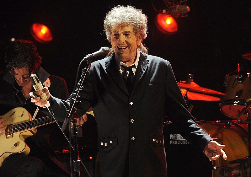 FILE - In this Jan. 12, 2012, file photo, Bob Dylan performs in Los Angeles. The music legend has quietly put concert tickets on sale for a tour in support of last year's album, &#x201c;Rough and Rowdy Ways.&#x201d; His website bills it as a &#x201c;World Wide Tour 2021-2024.&#x201d; (AP Photo/Chris Pizzello, File)