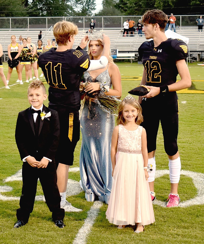 MARK HUMPHREY  ENTERPRISE-LEADER/Prairie Grove 2021 Homecoming Queen Toni Parish receives her crown from co-captain junior Paytin Higgns while co-captain senior Landon Semrad stands by with attendants, Gemma Lamb and Wyatt Jinks.