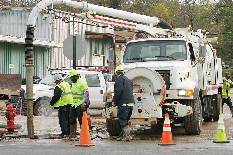 Workers with El Dorado Water Utilities prepare to repair a clean break in a cast iron pipe at the corner of East 5th Street and North Washington Street in this Dec. 9, 2016 file photo.