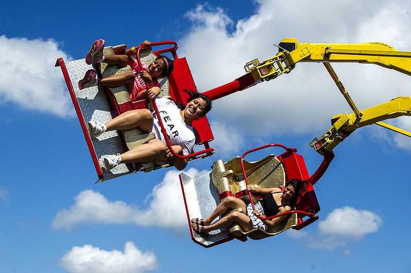 People ride the Cobra on the last day of the inaugural Pulaski County Fair at Riverfront Park in North Little Rock on Sunday, Oct. 3, 2021. See more photos at arkansasonline.com/104fair/

(Arkansas Democrat-Gazette/Stephen Swofford)