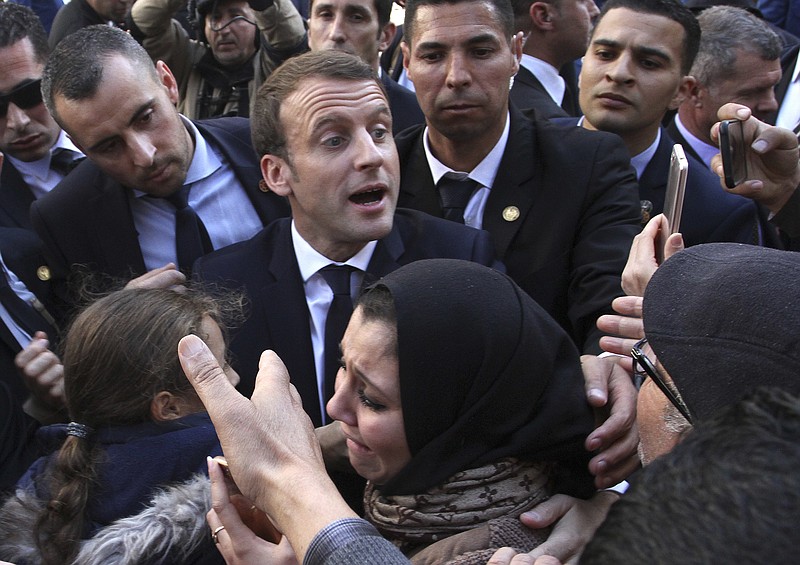 FILE- In this Dec.6, 2017 file photo, French President Emmanuel Macron meets residents in Algiers. Algeria has announced the immediate recall of its ambassador from Paris in a burst of fury over what it said were &quot;inadmissible&quot; comments attributed to French President Emmanuel Macron. (AP Photo/Anis Belghoul, File)