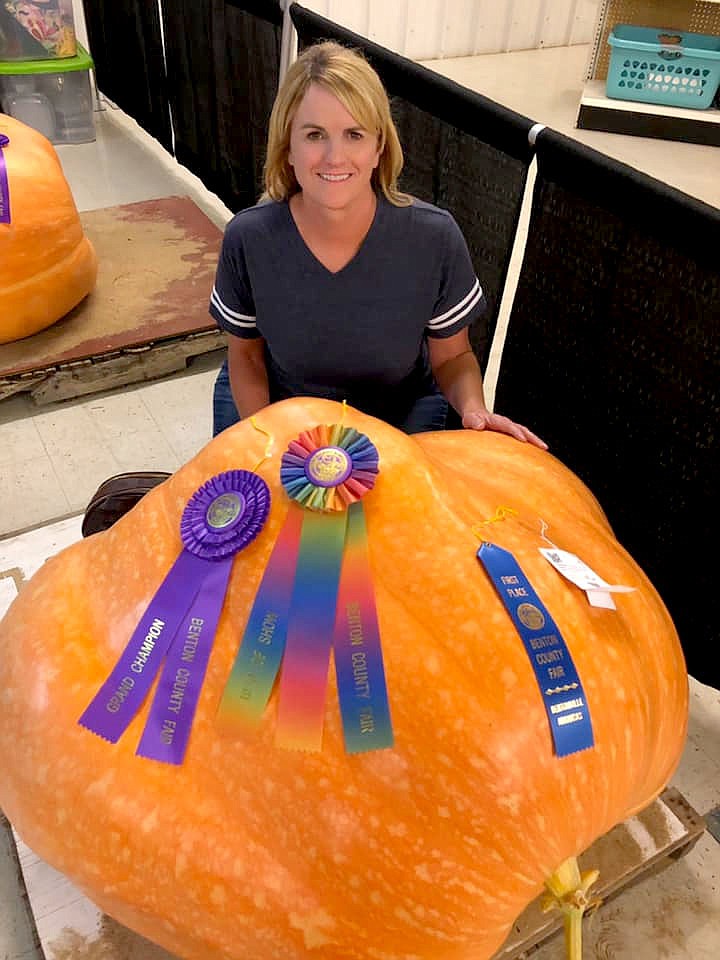 SUBMITTED
Melissa Bond poses with her 500-pound pumkin and ribbons she won at the Benton County Fair.