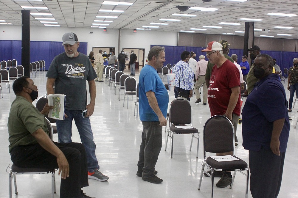 Lloyd Cato Jr. (left) and several racers talk excitedly after the meeting about the the proposed Pine Bluff Entertainment Park. (Pine Bluff Commercial/Eplunus Colvin)