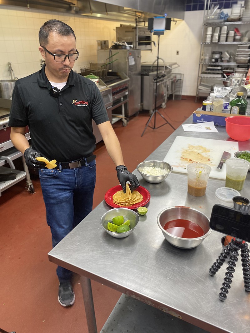 Juan Bustamante puts his skills on display for TC culinary arts students as part of the college's Hispanic Heritage Month activities. (Staff photo by Andrew Bell)