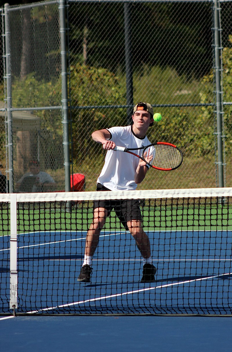 Hot Springs' Connor Bailey taps a shot back over the net in a singles match Monday in the 5A-South Conference Tennis Tournament at Lakeside. Bailey defeated Texarkana's Ryan Wardlaw, 0-6, 7-5, 6-0, to advance to Wednesday's semifinal round. - Photo by James Leigh of The Sentinel-Record