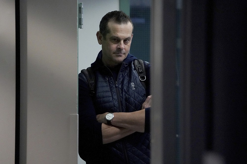 New York Yankees manager Aaron Boone waits in the hallway to attend a news conference at the American League Wild Card Workout Day at Fenway Park, Monday, Oct. 4, 2021, before Tuesday's American League Wild Card game against the Boston Red Sox in Boston. (AP Photo/Mary Schwalm)